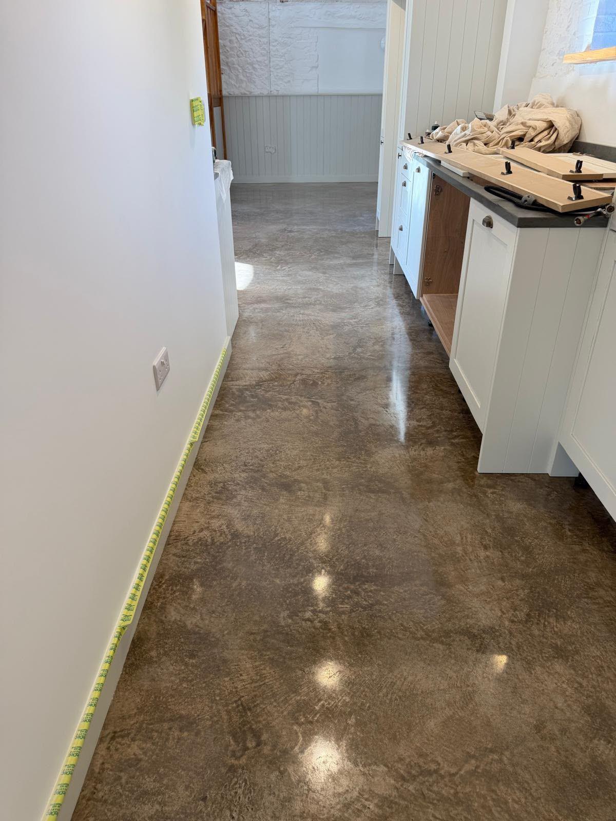 Polished concrete floor running through a renovated farmhouse kitchen