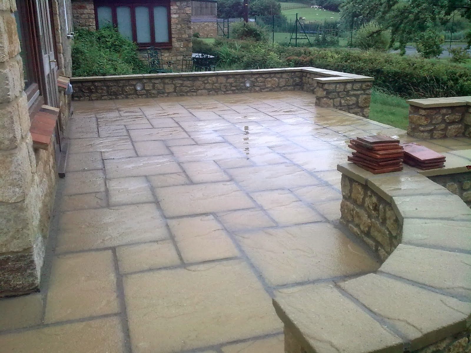 New sandstone patio with coursed stone walls, West Dorset