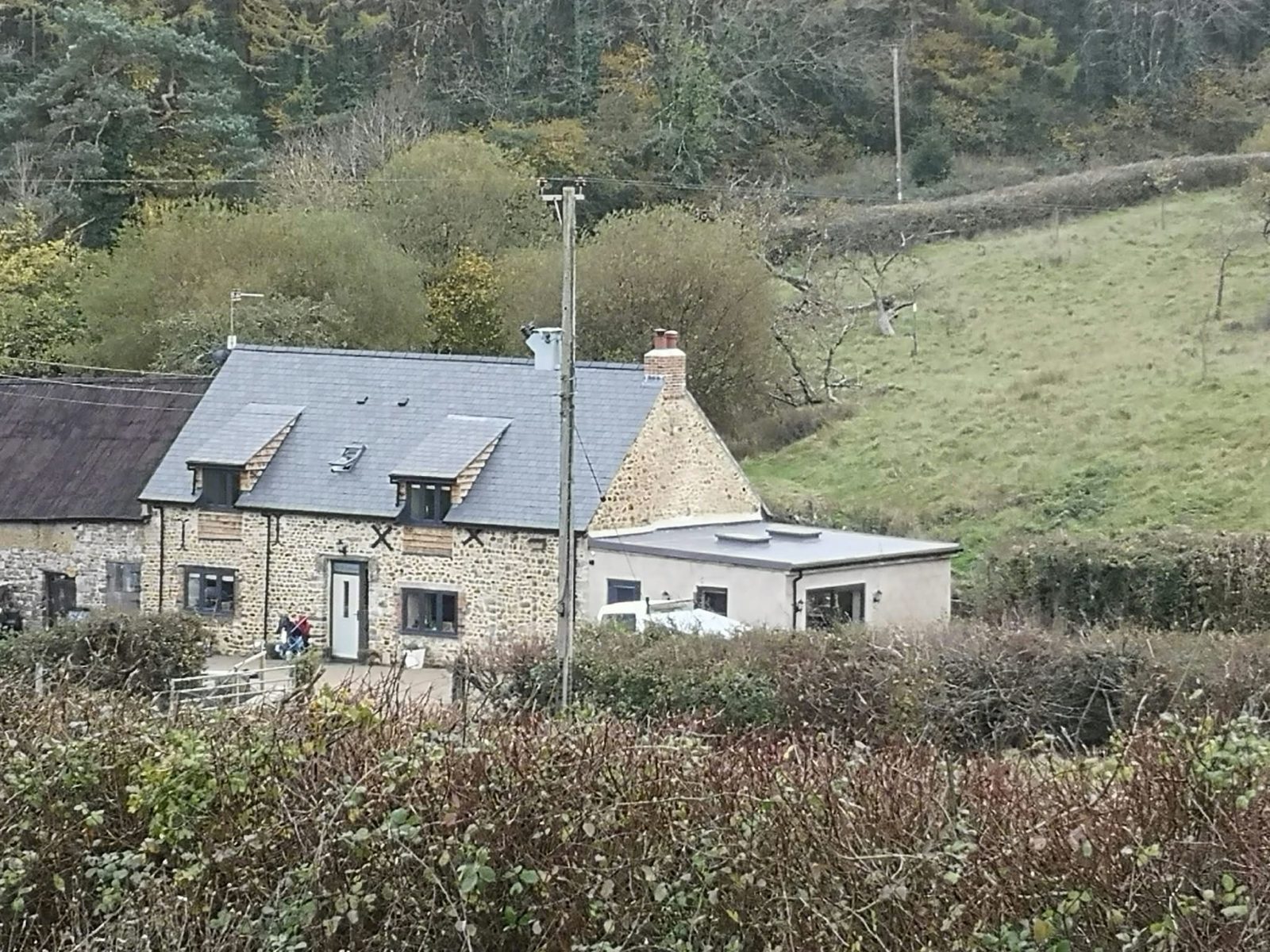 Stone cottages with slate roofs in a West Dorset valley