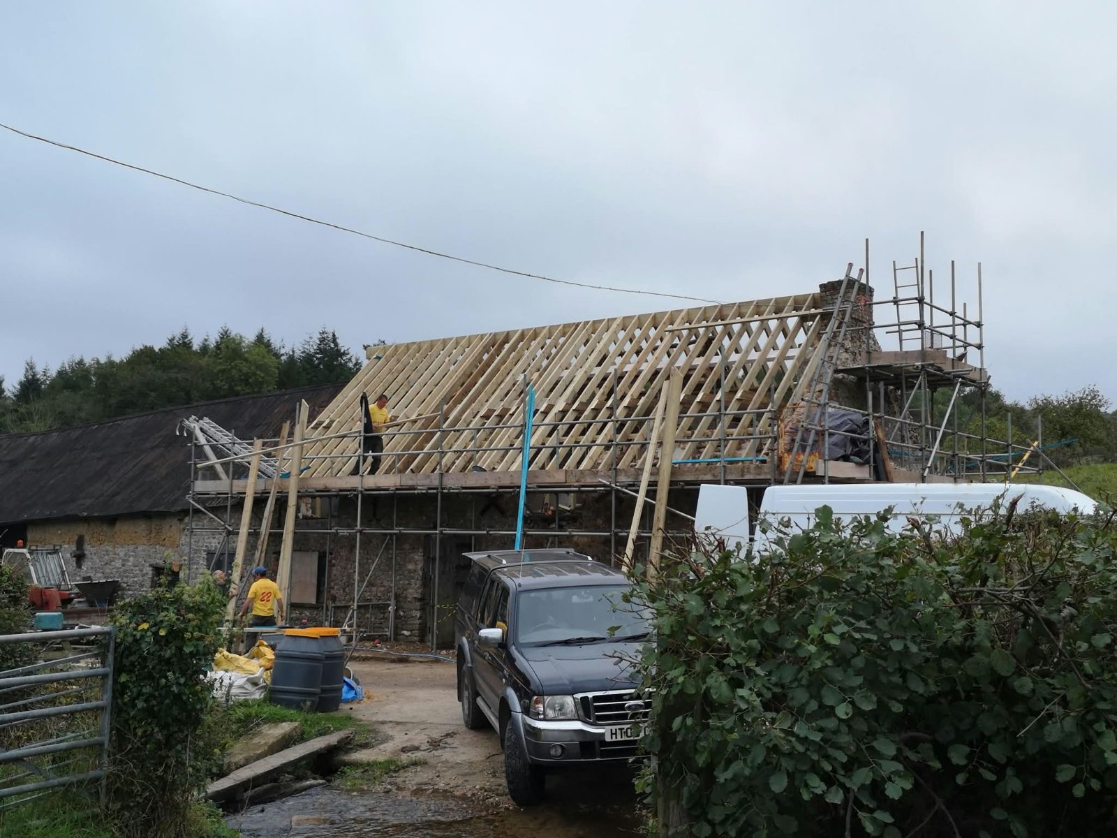 New timber roof structure going on a stone barn, scaffolded