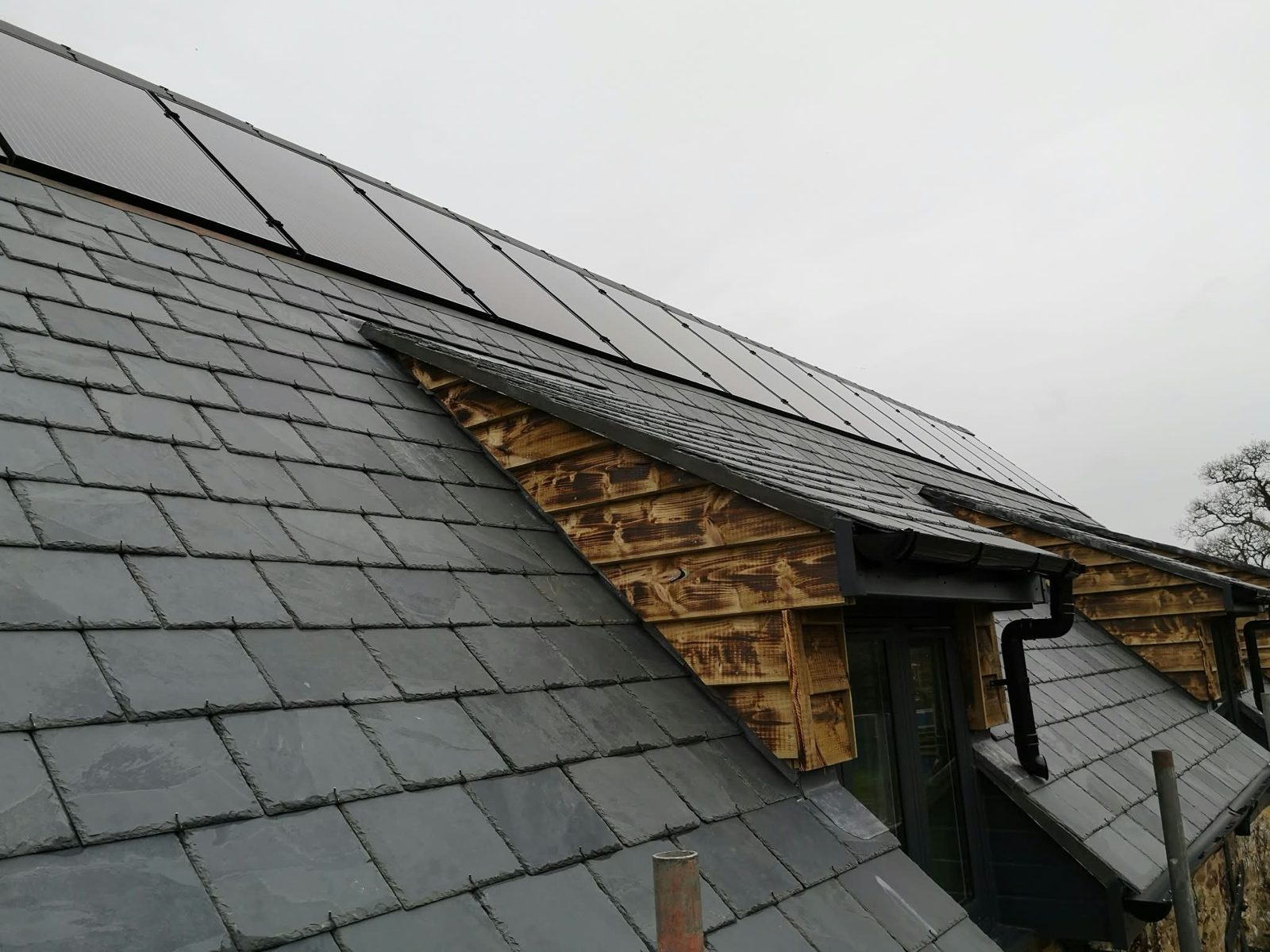 Natural slate roof with an oak-boarded dormer and new guttering